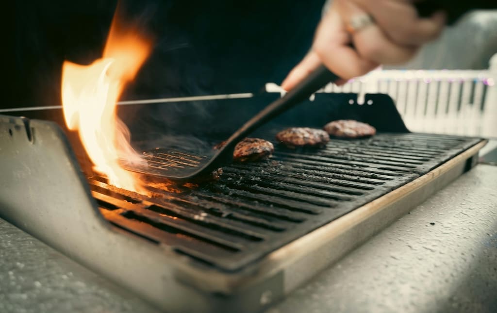 Hamburgers being cooked on the grill during a school fundraiser
