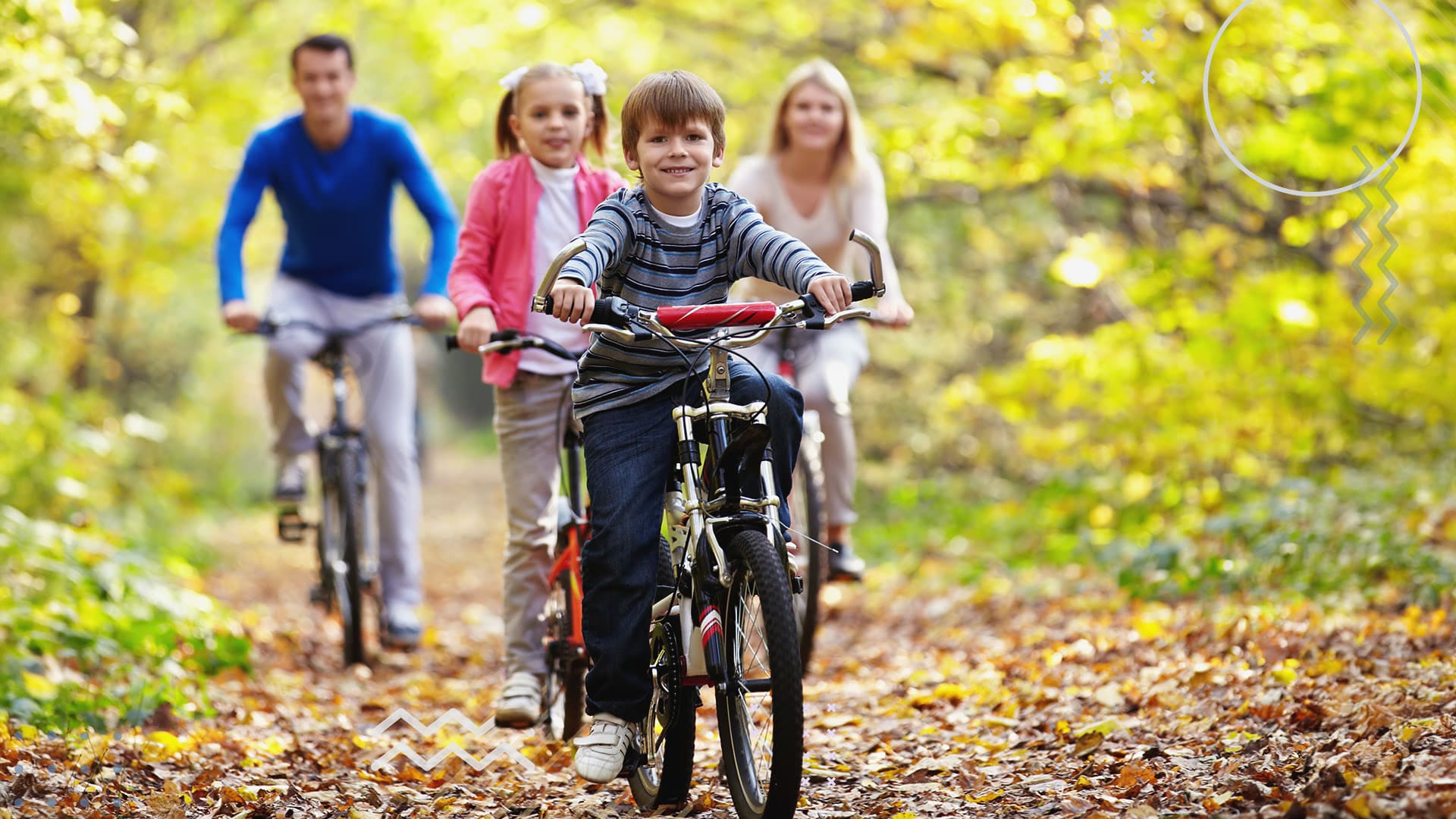 Young family riding their bikes together on a forest pathway