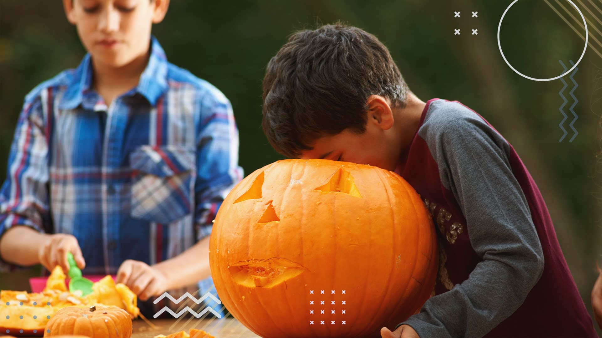 Kids carving pumpkins during a fall school fundraiser