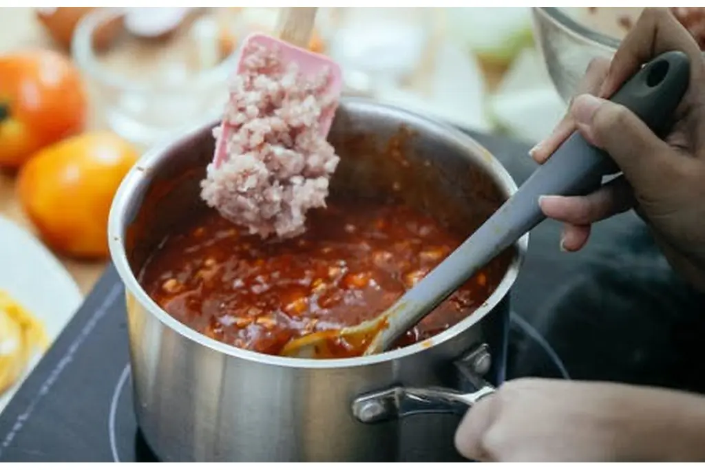 Cooking a thick, rich chili during a chili cook-off.