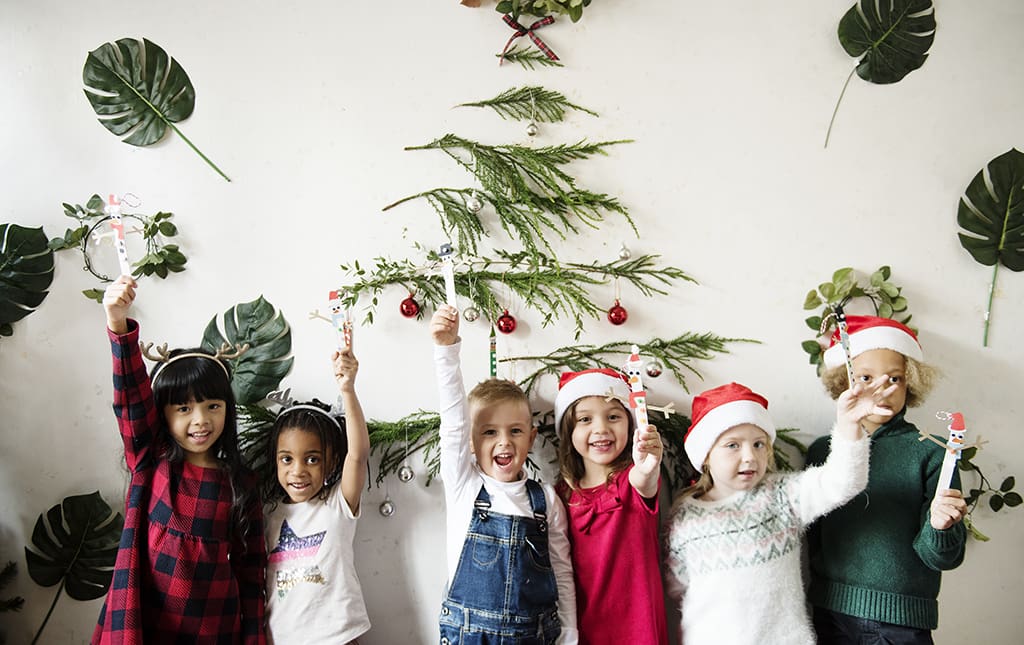 Kids smiling just before a Christmas tree collection and mulch event.