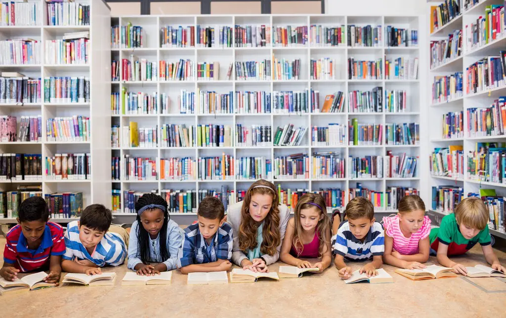 Students reading during a read-a-thon in the library.