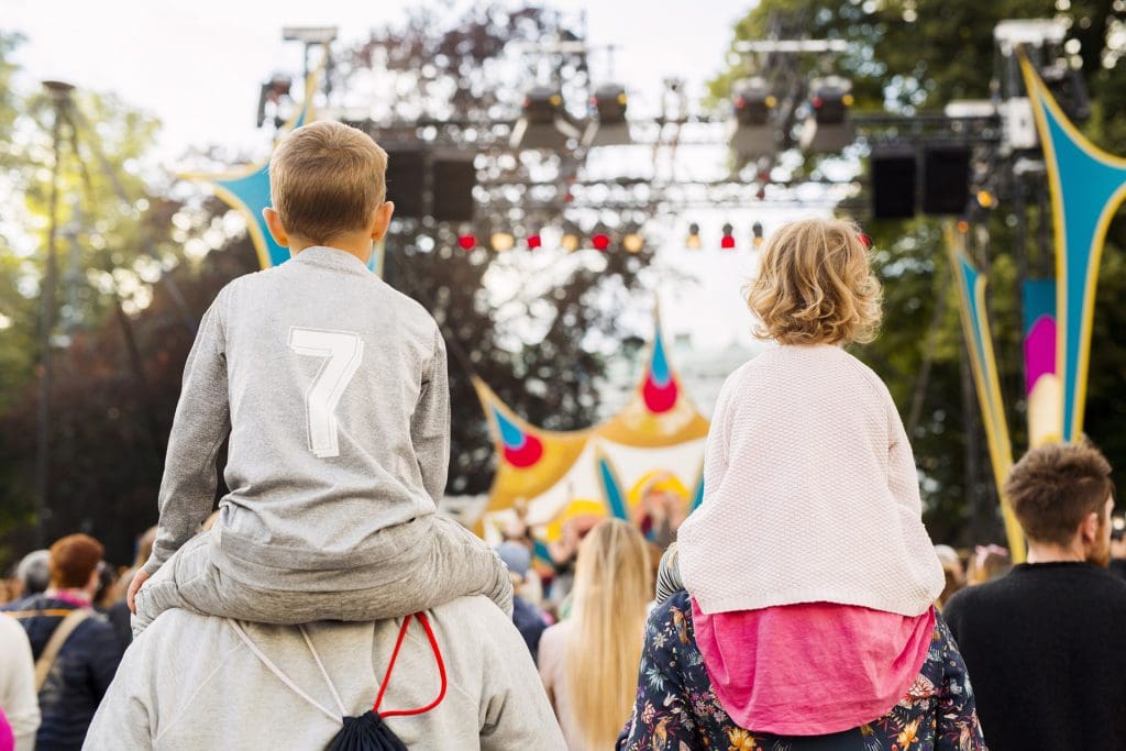 Two kids attending a school ticket festival.