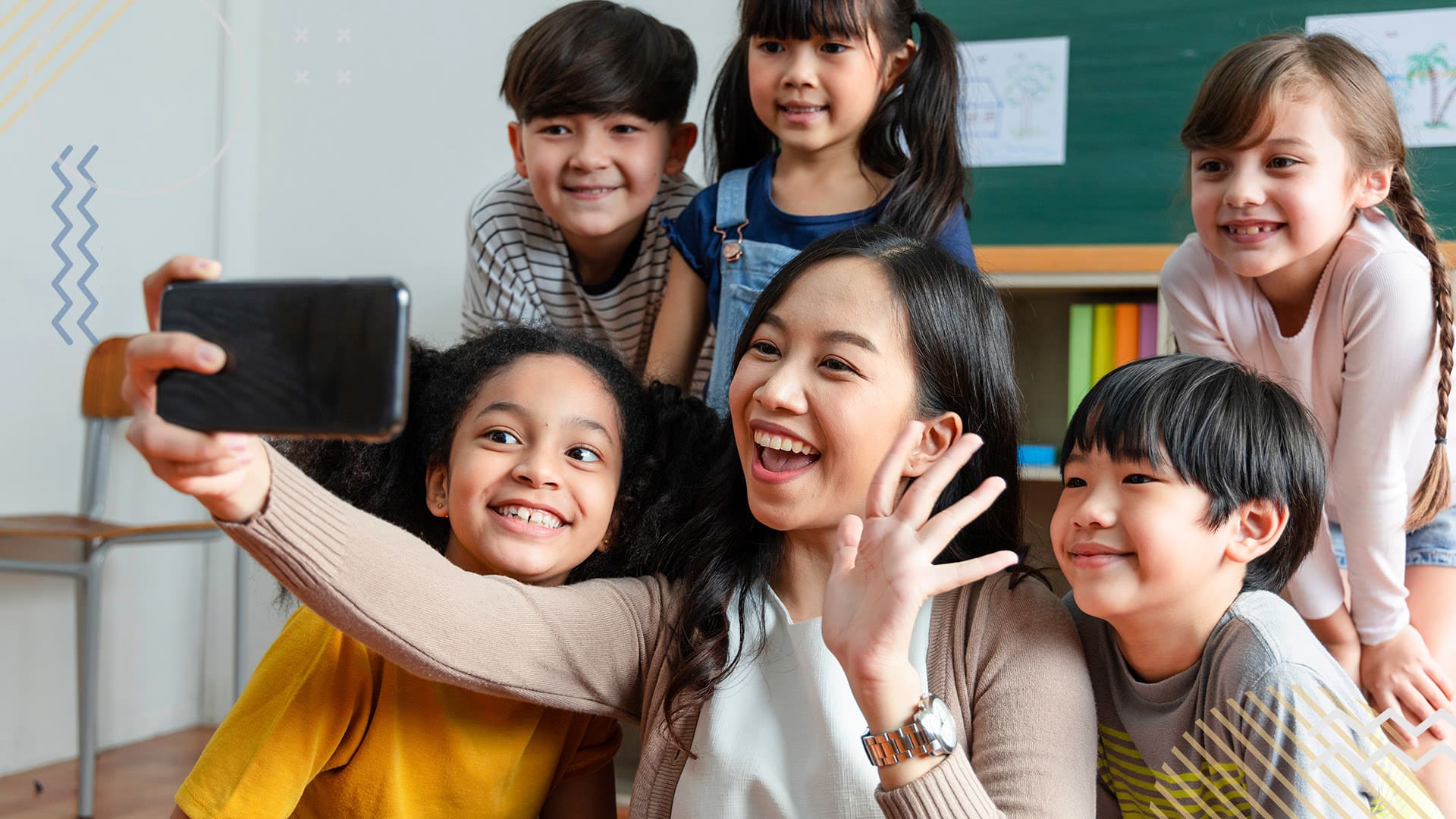 Teacher taking a selfie with a group of smiling students