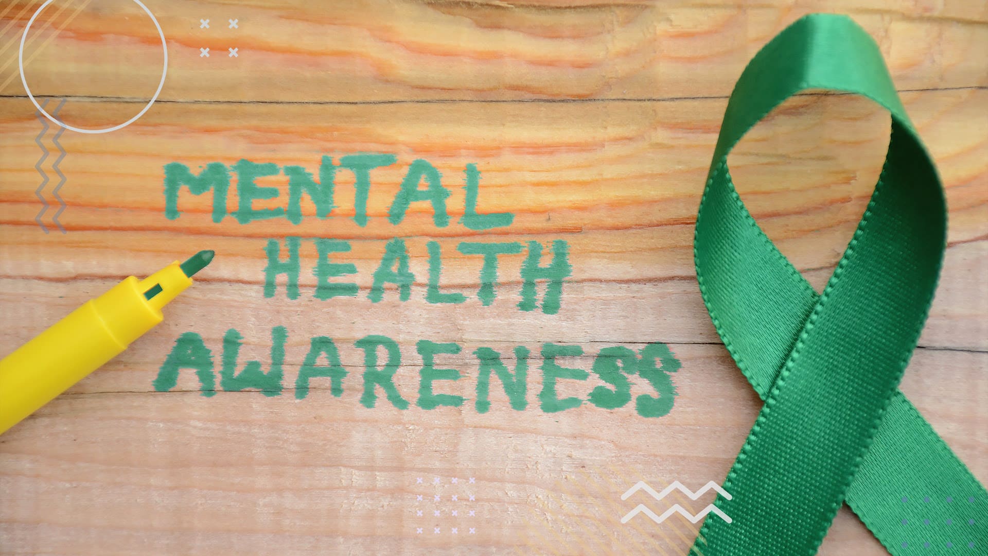 Mental health awarness fundraiser with green ribbon on wood table