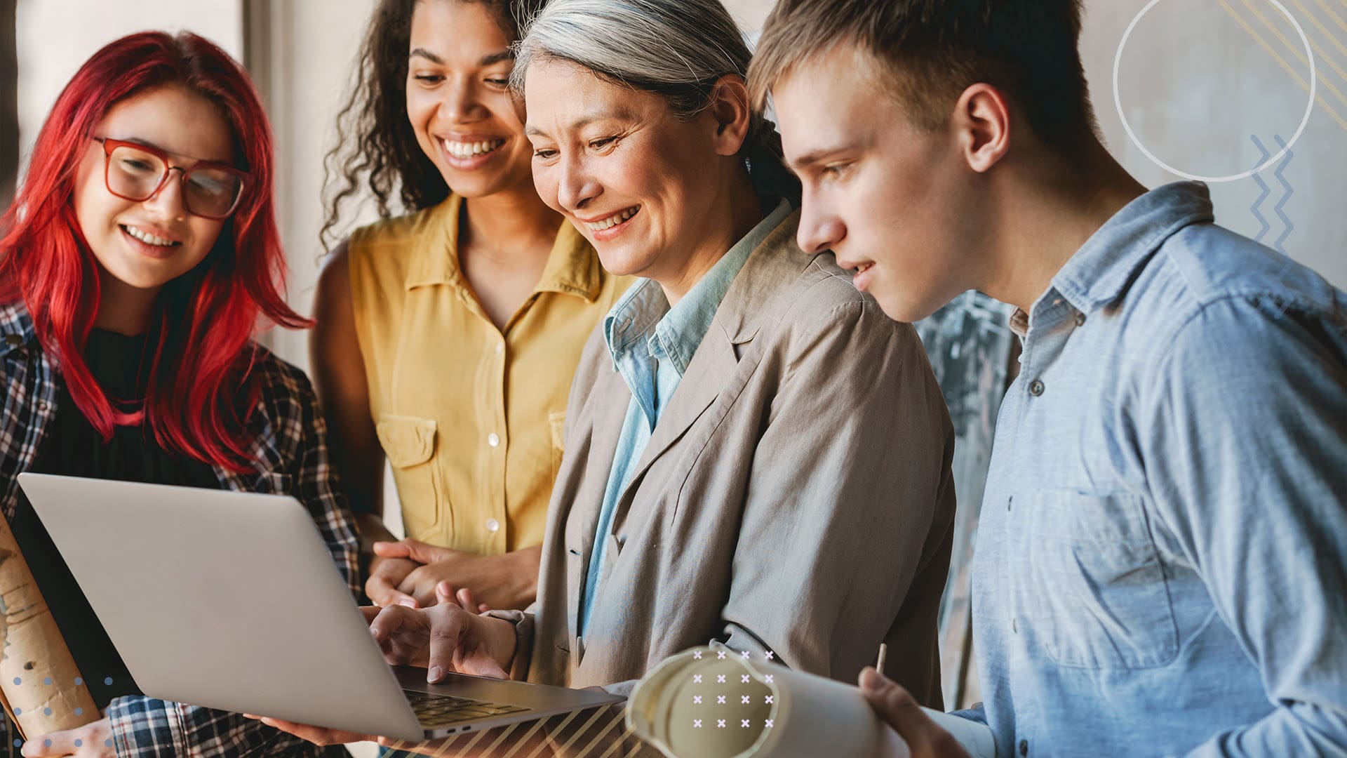 Group of people smiling while looking through a laptop