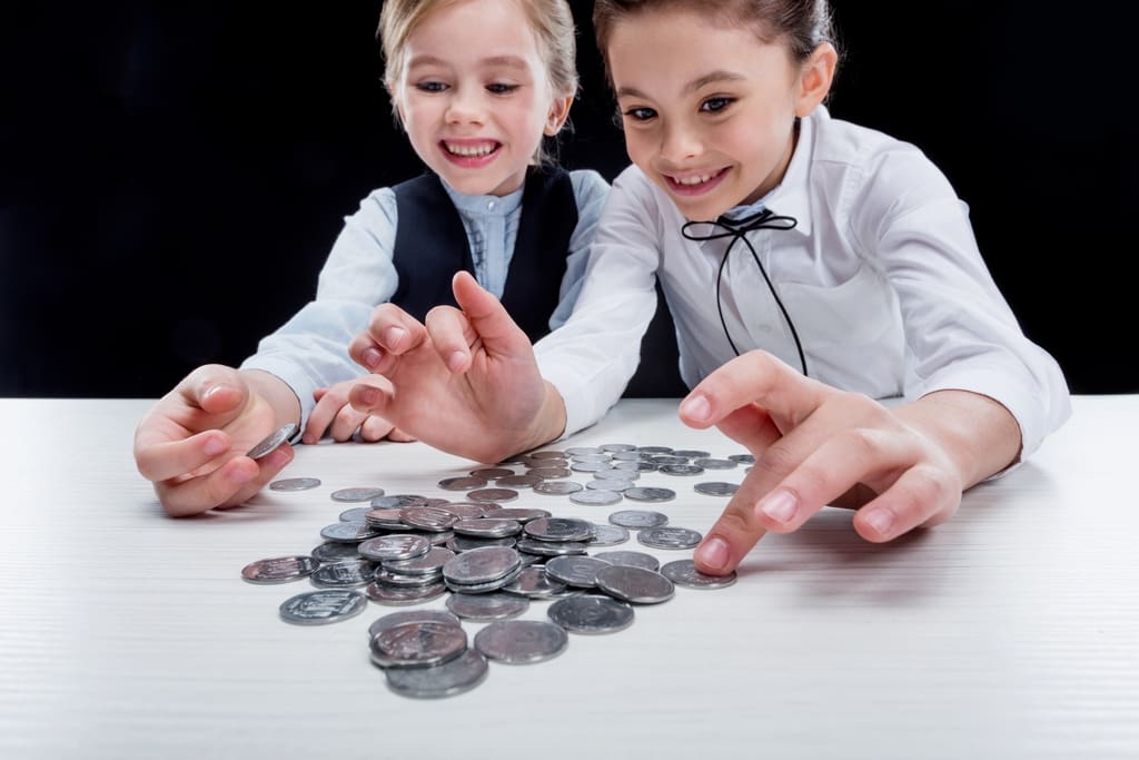 School students counting out coins for penny war fundraiser