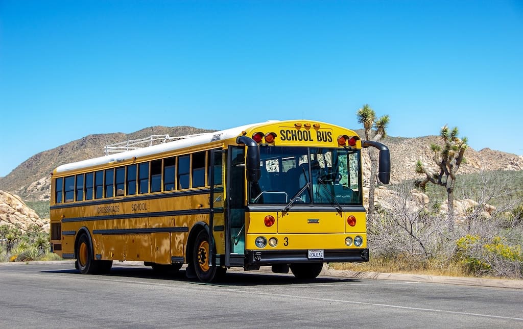 Yellow school bus driving in Palm Desert