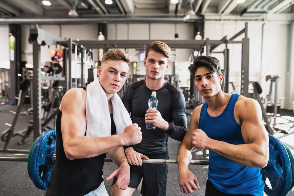 High school football team members celebrating in gym after Lift-A-Thon