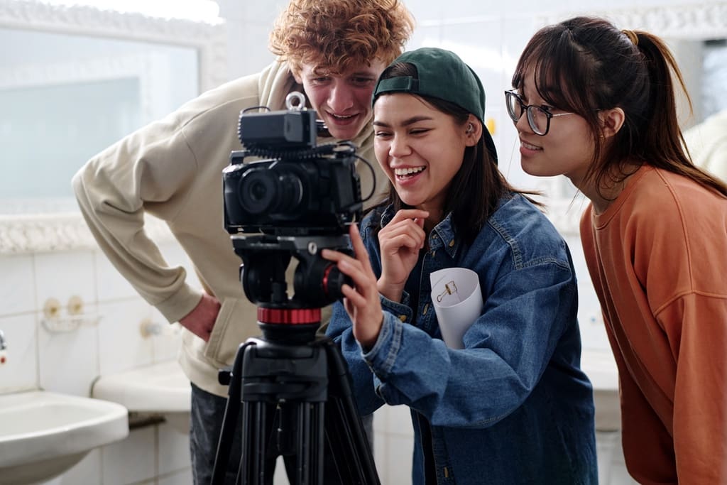 Students around video camera during shoot for fundraiser hype video