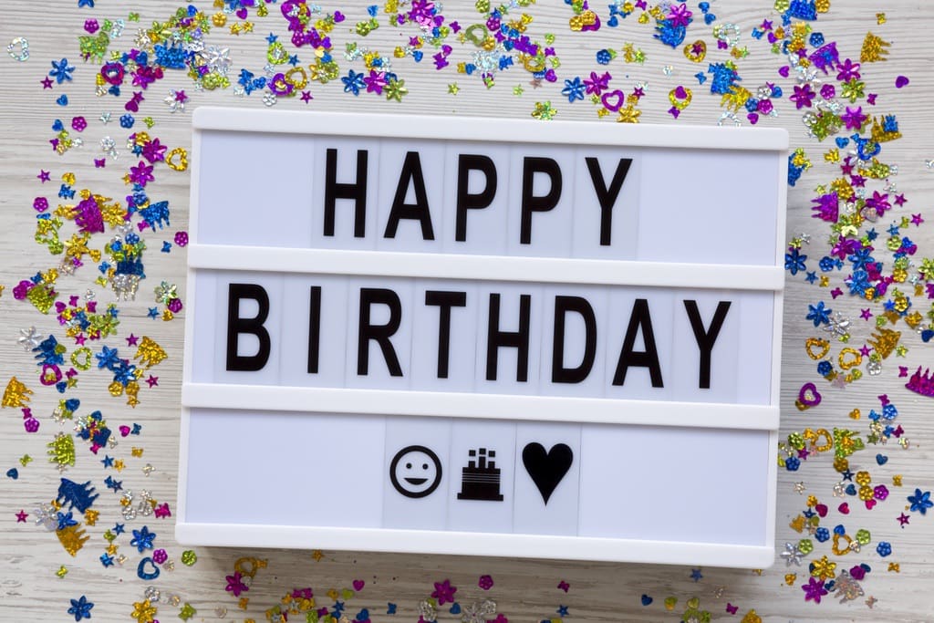 Board hung on wall with the words Happy Birthday written on it