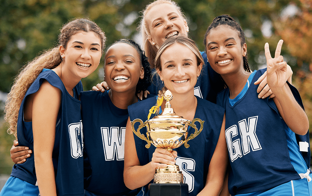 A high school team and coach after winning a tournament