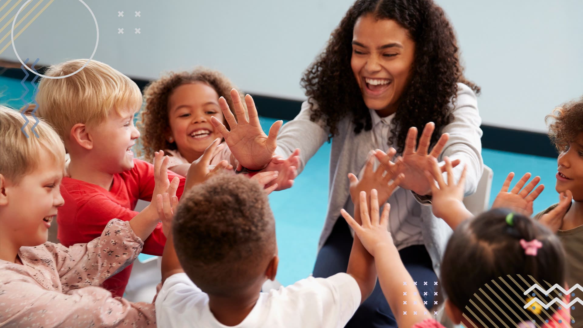 Volunteer smiling and laughing while high fiving students